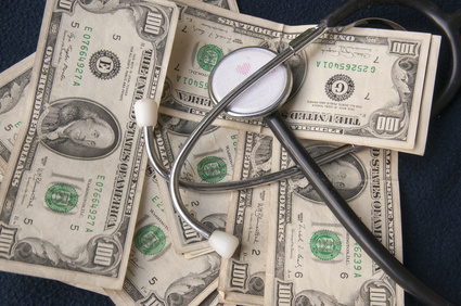 the health costs: a stetoscopio supported on the dollars