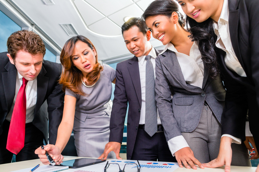 Businesspeople standing around a table