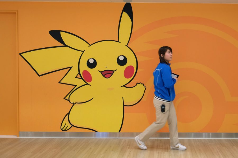 An employee walks past a wall featuring the Pikachu character at the Pokemon Center Mega Tokyo store in Tokyo, Japan, on Wednesday, Feb. 24, 2016. Pokemon, a multi-media franchise by Nintendo Co., will mark its 20th anniversary on Feb. 27. Photographer: Yuriko Nakao/Bloomberg via Getty Images