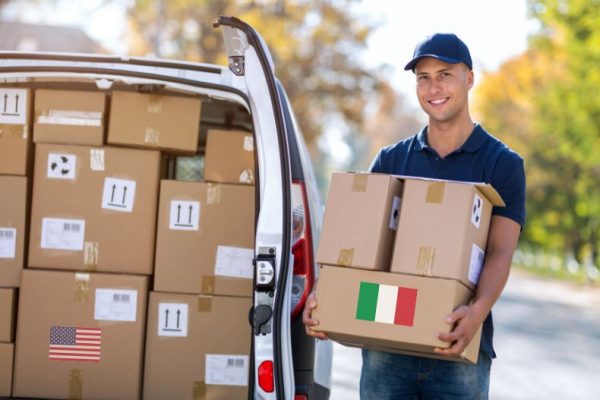 delivery man carrying shipping items