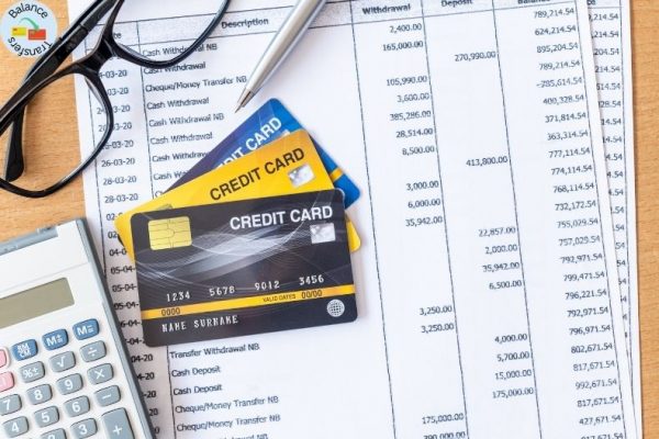 Credit cards placed on a billing statement representing a credit card balance transfer.