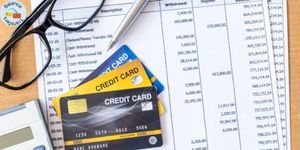 Credit cards placed on a billing statement representing a credit card balance transfer.