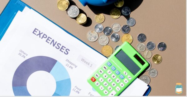 logbook for expenses with calculator, coins